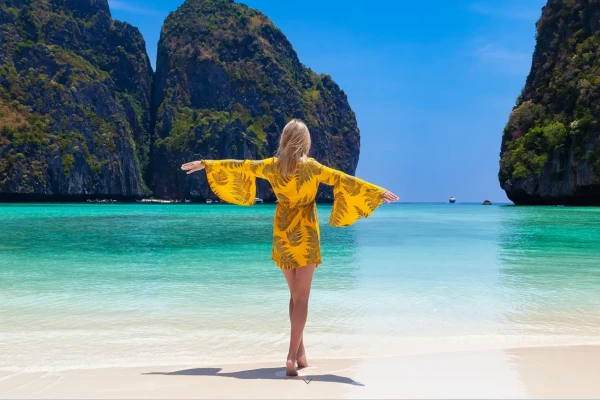 Traveler at Maya Bay beach on Phi Phi Island Tour from Phuket with turquoise water and limestone cliffs