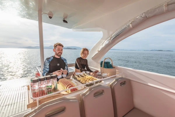 Guests enjoying snacks and drinks onboard the Phi Phi catamaran from Phuket