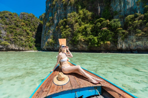 Traveler enjoying a traditional longtail boat ride at Pileh Lagoon on Phi Phi Leh Island