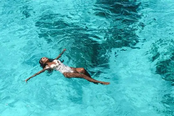 Guest floating in clear turquoise water during the Phi Phi luxury yacht tour
