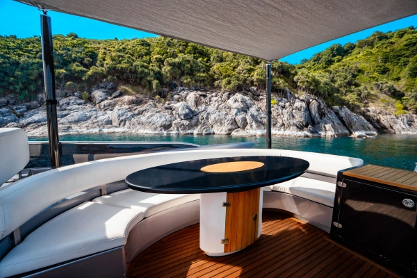 Shaded outdoor lounge with island views on the Phi Phi luxury yacht