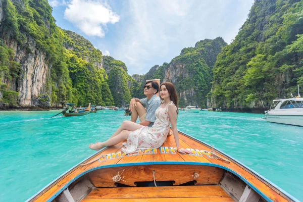 Couple enjoying a long-tail boat experience at Pileh Lagoon during a Phi Phi Island tour