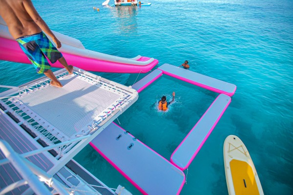 Guest using the water slide during the Phi Phi late morning speed catamaran tour