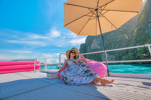 Guest relaxing on the upper deck during the Phi Phi Island Late Morning Tour from Phuket by speed catamaran