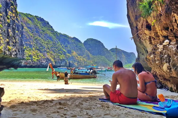 Couple relaxing on a quiet beach during the Phi Phi Island Sunrise Tour