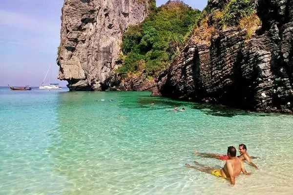 Guests swimming in clear shallow water during a regular Phi Phi Island day tour