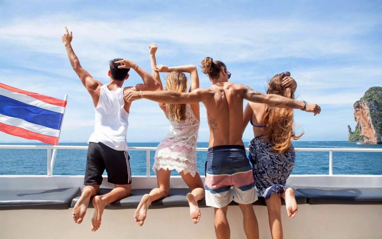Group of travelers enjoying the open deck during a Phi Phi Island cruise from Phuket