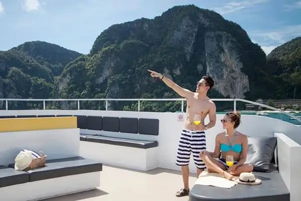 Passengers relaxing on the open deck as the Phi Phi Island cruise departs from Phuket