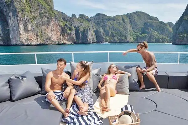 Travelers relaxing on the open deck during a Phi Phi Island cruise from Phuket