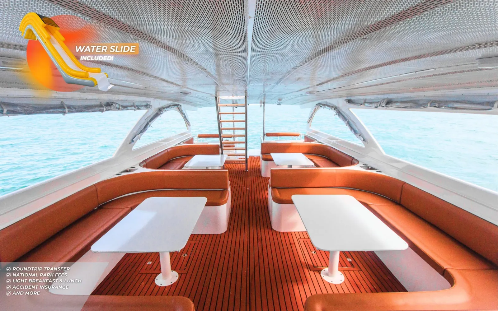Spacious speed catamaran interior with sofa seating and water slide for the Phi Phi Bamboo and Khai Island Tour from Phuket
