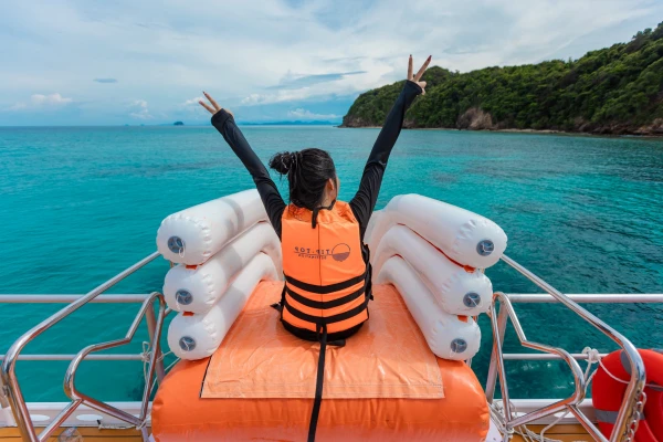 Traveler enjoying the inflatable water slide on the speed catamaran near Maiton Island
