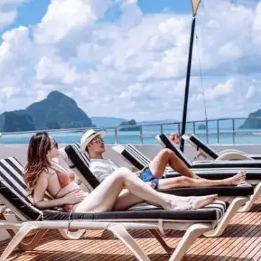 Guests relaxing on a luxury James Bond Island cruise sundeck in Phang Nga Bay