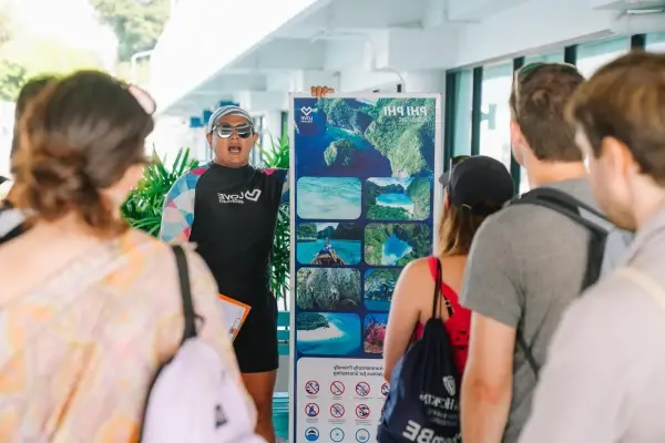 Tour guide giving a program and safety briefing before the Phi Phi and Maiton Island catamaran tour