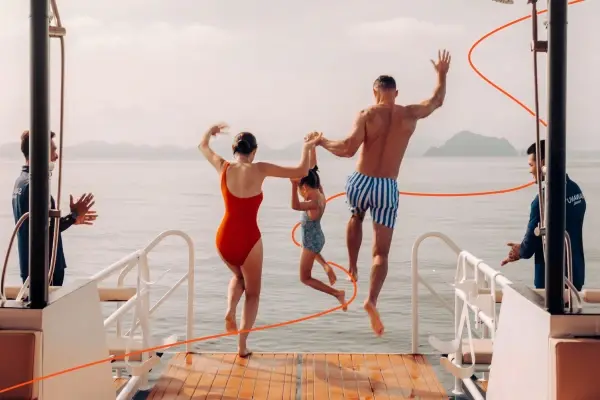 Family enjoying water activities from a Phi Phi catamaran during a tour from Phuket