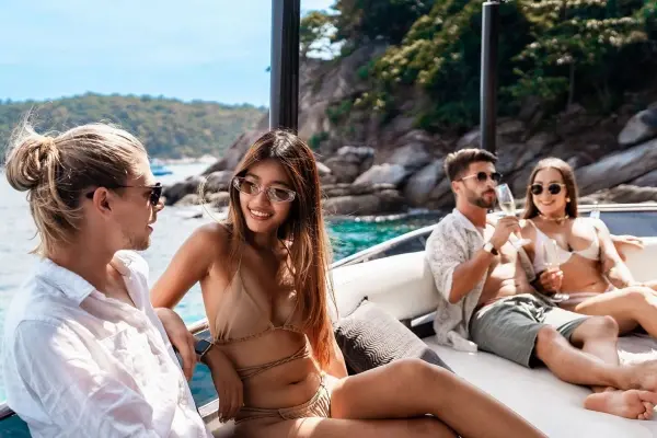 Four guests relaxing in the outdoor lounge of the Phi Phi luxury yacht
