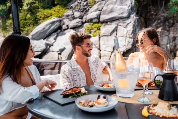 Guests enjoying gourmet lunch and sparkling wine on the Phi Phi luxury yacht