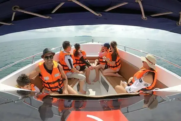 Small-group passengers wearing life jackets aboard a speedboat on the Phi Phi Island Sunset Tour from Phuket