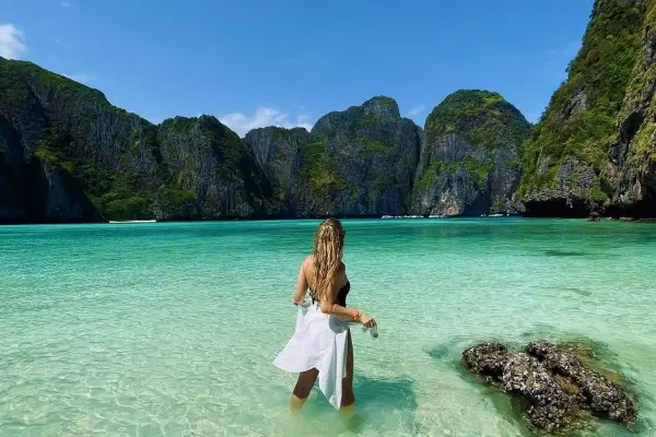 Maya Bay with white sand, clear turquoise water and limestone cliffs during the Phi Phi Island luxury catamaran tour