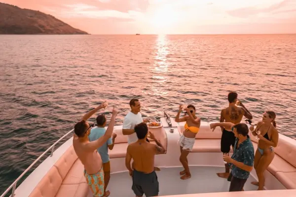 Guests relaxing with sunset views and music aboard the Phi Phi Island luxury catamaran