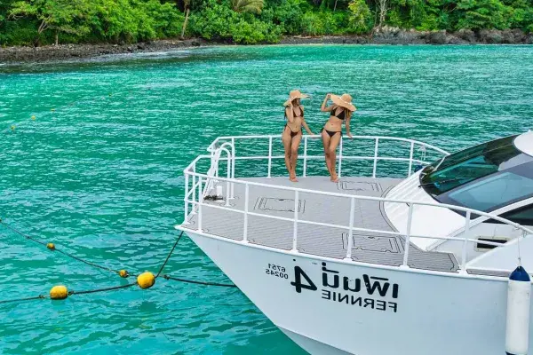 Travelers standing on the front deck of a premium Phi Phi catamaran from Phuket