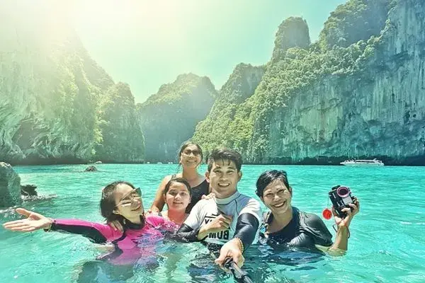 Guests swimming in the emerald water of Pileh Lagoon during the Phi Phi Island Sunrise Tour from Phuket