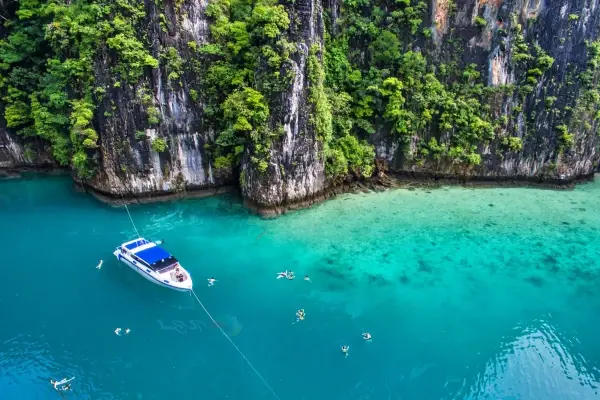 Guests snorkeling beside a speedboat during the Phi Phi Island Sunrise Tour