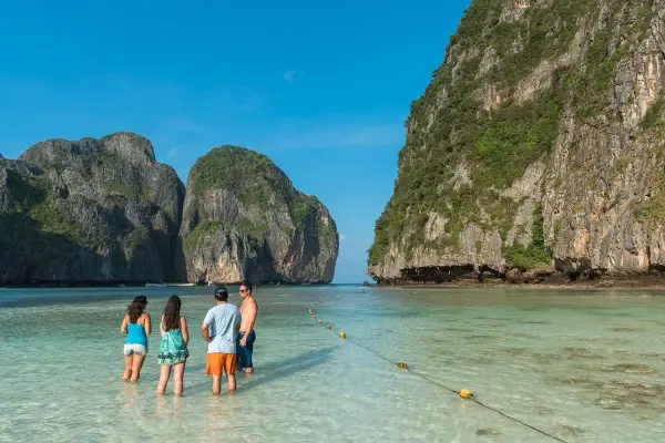 Travelers visiting Maya Bay during the Phi Phi Island Sunset Tour from Phuket