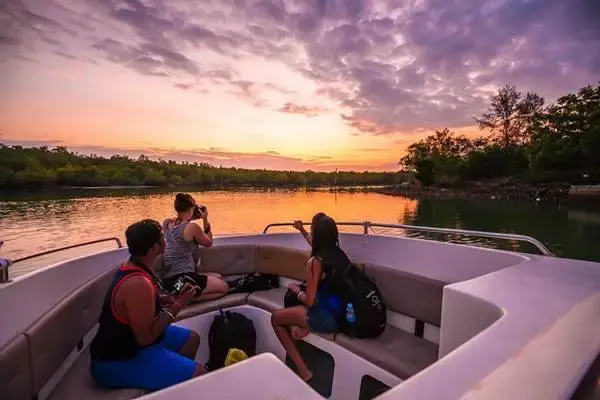 Guests watching the sunrise from a speedboat during the Phi Phi Island Sunrise Tour from Phuket