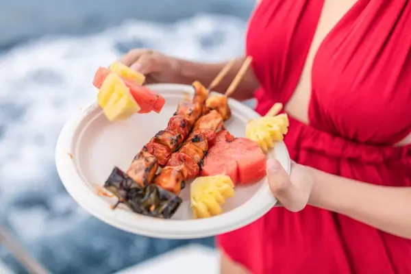 BBQ chicken and seasonal fruit served onboard during the PP3 Phi Phi Luxury Speed Catamaran Tour
