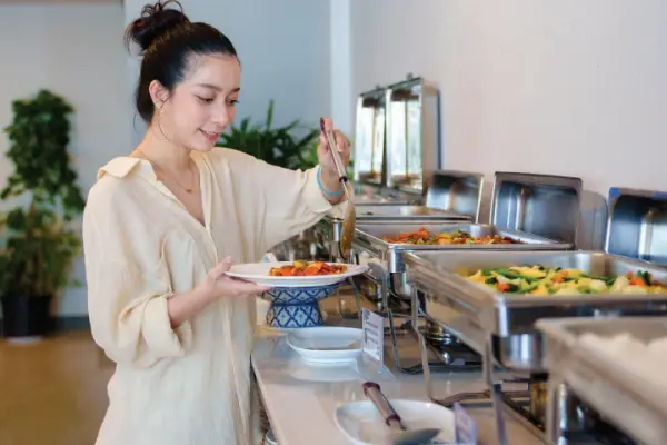 Guest choosing food from a buffet lunch on Phi Phi Don Island during the Phi Phi Island cruise tour