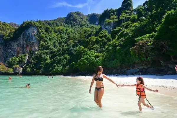 Family enjoying shallow turquoise water during the Bamboo Island tour