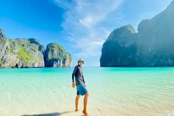 Traveler enjoying Maya Bay beach and turquoise water during the Phi Phi Bamboo Island Tour from Phuket