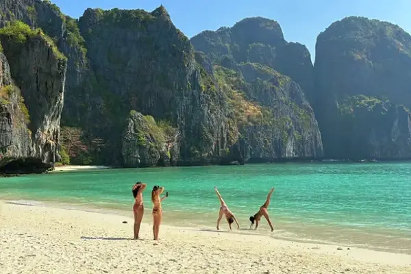 Travelers enjoying Maya Bay beach and limestone scenery during the Phi Phi Bamboo and Khai Island Tour from Phuket