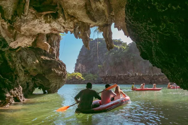 Sea cave canoeing through limestone caves in Phang Nga Bay on the Phi Phi and James Bond Island tour