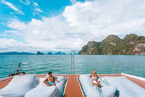 Guests relaxing on a luxury catamaran in Phang Nga Bay