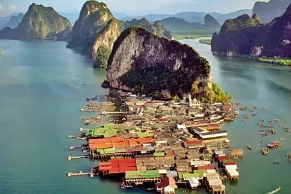 Aerial view of Koh Panyee fishing village surrounded by limestone islands in Phang Nga Bay
