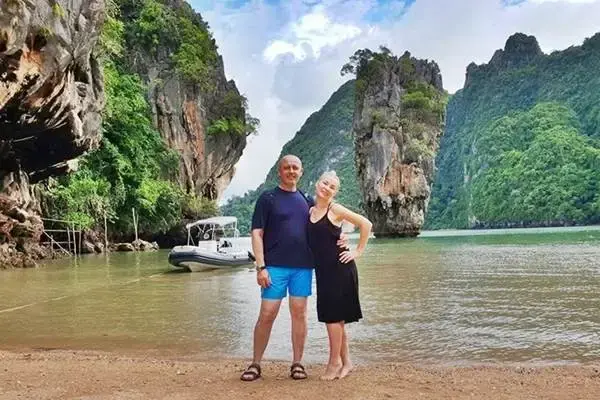 Visitors sightseeing at James Bond Island during a sunset tour through Phang Nga Bay from Phuket