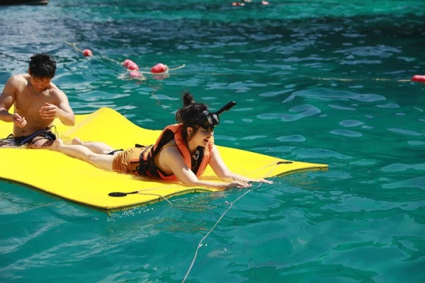 Guests enjoying water activities during the Phi Phi Maya Bay and Maiton Island comfortable catamaran tour