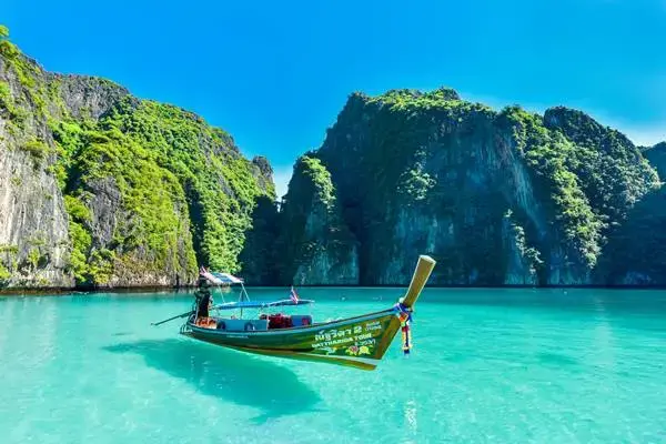 Traditional longtail boat in turquoise water during the Loh Samah Bay and Pileh Lagoon stop at Phi Phi Leh