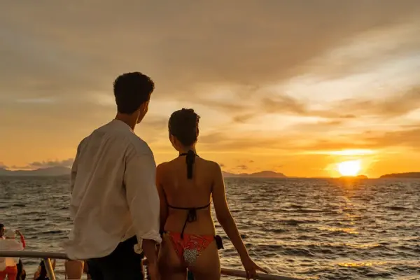 Couple watching the sunset during a luxury catamaran tour from Phuket