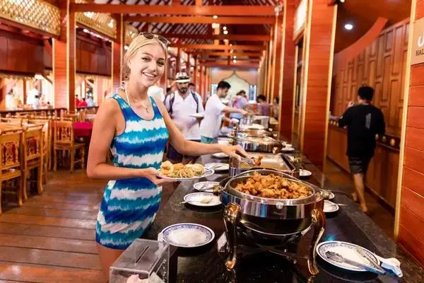 Tourist enjoying a buffet lunch at Koh Panyee during a Phang Nga Bay tour