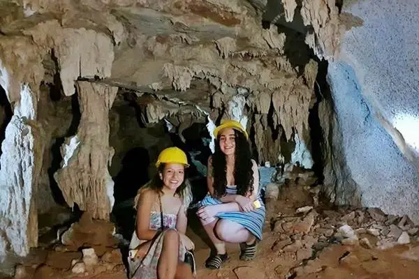 Guests exploring a limestone cave during the James Bond Island late morning tour from Phuket