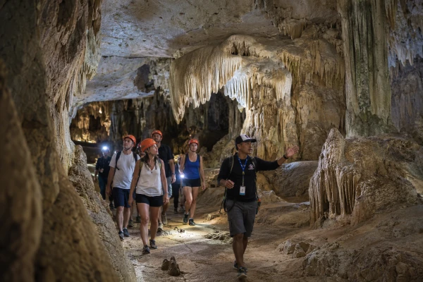 Tour guide leading guests through a limestone cave at Panak Island on the James Bond Island late morning tour from Phuket