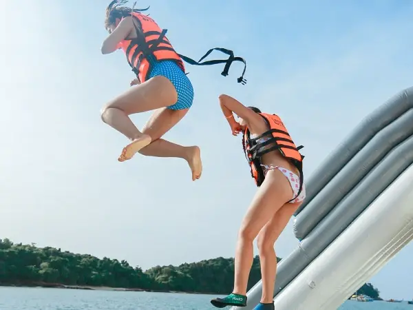 Guests using the sea slide on the James Bond Island luxury power catamaran tour from Phuket