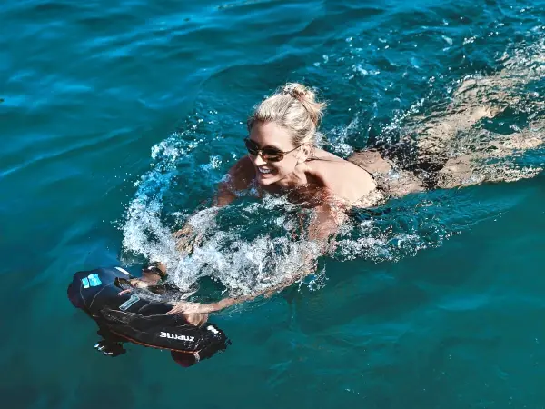 Guest swimming with a sea scooter during the James Bond Island luxury power catamaran tour from Phuket