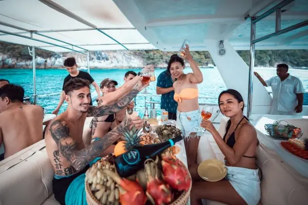 Guests enjoying drinks and refreshments onboard the James Bond Island luxury power catamaran tour from Phuket