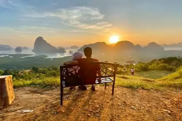 Couple watching sunrise over Phang Nga Bay from Samet Nangshe Viewpoint