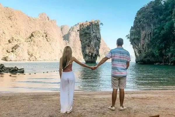 Couple enjoying the view of Khao Tapu at James Bond Island during an early morning tour from Phuket