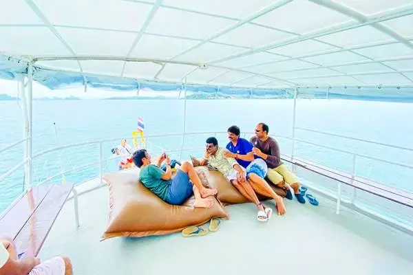 Guests relaxing on the upper deck of the big boat during a Phang Nga Bay tour