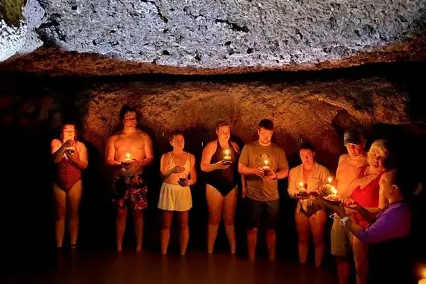 Guests holding Loy Krathong inside a sea cave during the Phang Nga Bay evening tour